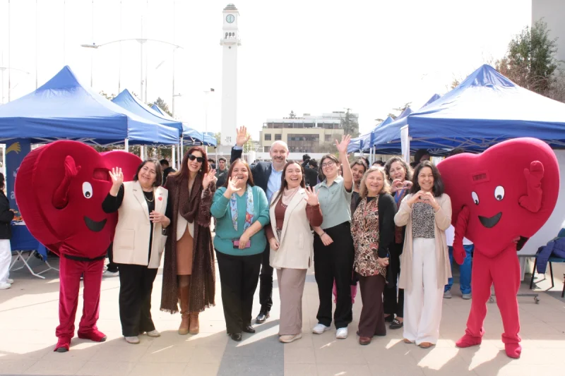 Autoridades de la Universidad de Concepción posan junto a corpóreos de corazón.